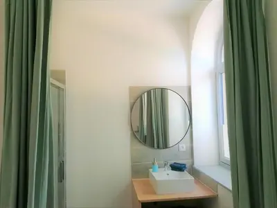 a bathroom with a sink and a mirror at Gîte de Las Cases 4 à 6 personnes in Lempaut
