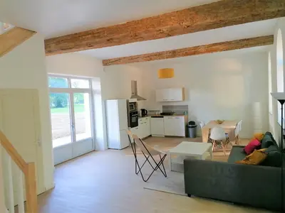 a living room with a couch and a table at Gîte de Las Cases 4 à 6 personnes in Lempaut
