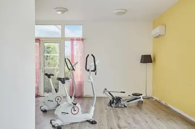 two exercise bikes in a room with a window at Résidence Odalys Côté Canal in Sallèles-dʼAude