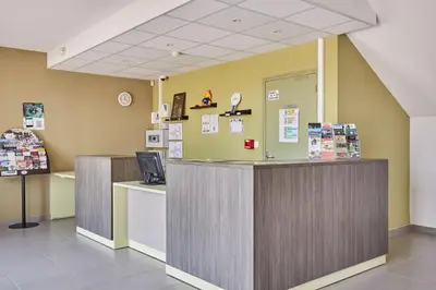 a waiting area of a hospital with a counter at Résidence Odalys Côté Canal in Sallèles-dʼAude