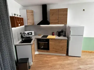 a small kitchen with a refrigerator and a microwave at Studio les Rosiers in Quillan
