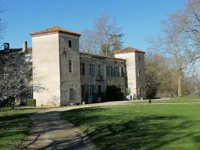 a large building with a grassy field in front of it at Gîte des Cathares 2 personnes in Lempaut