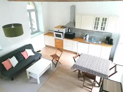 a living room with a couch and a table at Gîte des Cathares 2 personnes in Lempaut