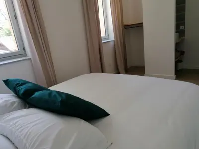 a green pillow sitting on top of a white couch at Gîte des Cathares 2 personnes in Lempaut