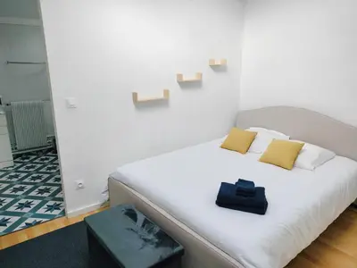 a white bed with two pillows on it in a room at L'Orangerie 14 personnes in Lempaut