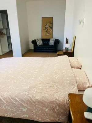 a bedroom with a bed and a couch at Maison de Village - Standing - Centre Historique in Sigean