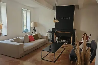 a living room with a couch and a fireplace at Hébergement - Canal du midi in Saint-Martin-Lalande