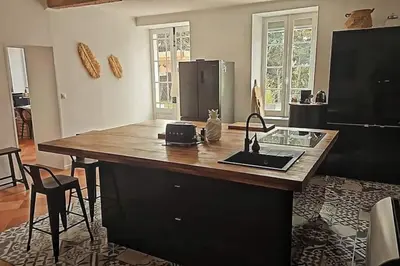 a kitchen with a island with a counter top at Hébergement - Canal du midi in Saint-Martin-Lalande