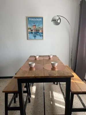 a wooden table with bowls on top of it at Maison 2 chambres 3 lits 4 couchages et extérieur in Villefranche-de-Lauragais