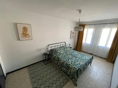 a bedroom with a bed in a room with a window at Maison 2 chambres 3 lits 4 couchages et extérieur in Villefranche-de-Lauragais