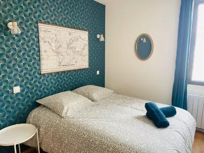 a bedroom with a bed and a map on the wall at Studio Charles de Gaulle V in Castres