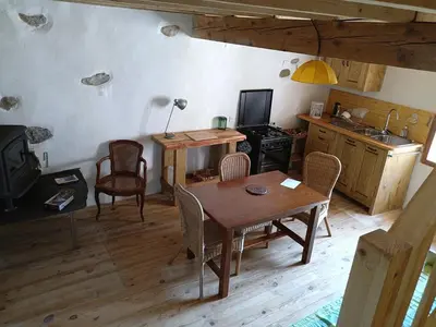 a kitchen and dining room with a table and chairs at maison dans village rural in Saint-Louis-et-Parahou