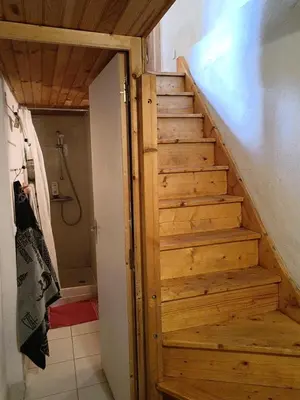 a wooden staircase in a bathroom with a shower at maison dans village rural in Saint-Louis-et-Parahou