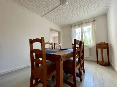 a dining room table and chairs in a room at Maison Les Bruyères - 3 chambres - jardin et parking à Carcassonne in Carcassonne