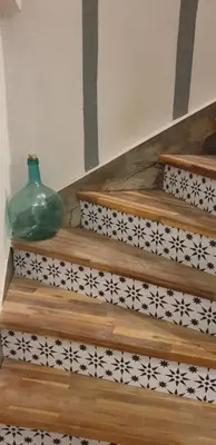 a glass vase sitting on a staircase with black and white tiles at LA PETITE BICOQUE au fond du jardin in Quillan