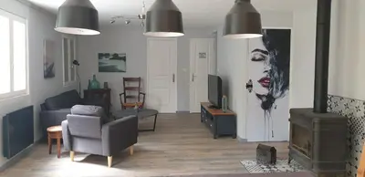 a living room with a couch and a tv at LA PETITE BICOQUE au fond du jardin in Quillan