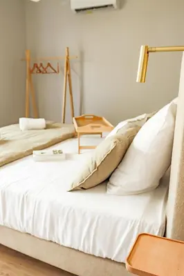 a bedroom with two beds and a table at Les Gîtes de Laure - L'Eden Romantique, B&B, Spa privatif et Petit Déjeuner, Couloir de nage, 10mn Carcassonne in Malves-en-Minervois
