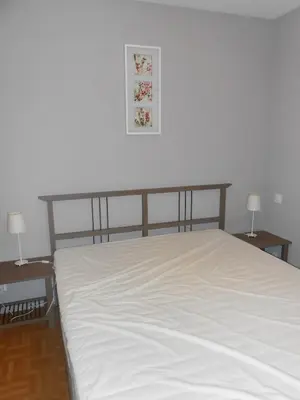 a bed in a room with two tables and two lamps at Superbe villa 4 ch climatisées avec piscine privée in Roquetaillade