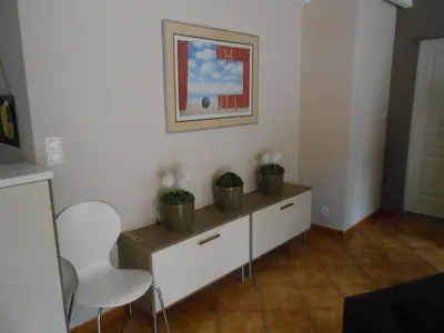a living room with two plants on a cabinet at Superbe villa 4 ch climatisées avec piscine privée in Roquetaillade