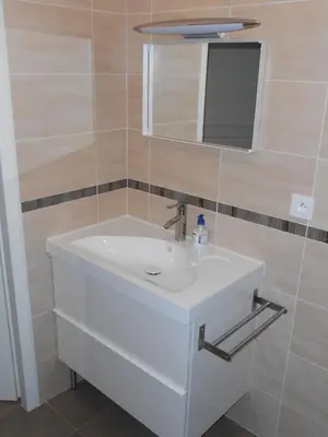 a bathroom with a white sink and a mirror at Superbe villa 4 ch climatisées avec piscine privée in Roquetaillade