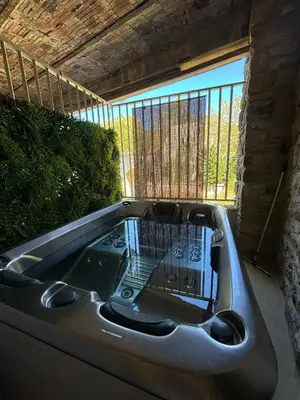 a bath tub sitting in front of a window at La Barbacane de Cascastel-des-Corbières in Cascastel-des-Corbières