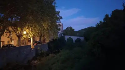 a night view of a building and a bridge at La Barbacane de Cascastel-des-Corbières in Cascastel-des-Corbières