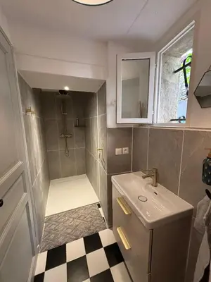 a small bathroom with a sink and a shower at La Barbacane de Cascastel-des-Corbières in Cascastel-des-Corbières