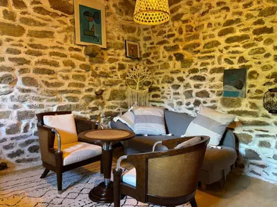 a room with two chairs and a couch and a table at La Barbacane de Cascastel-des-Corbières in Cascastel-des-Corbières