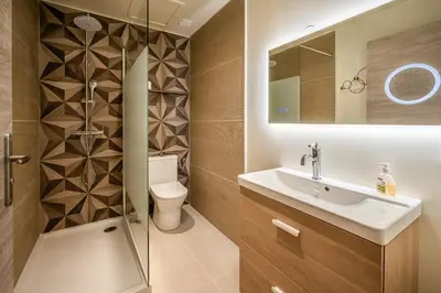 a bathroom with a shower and a sink and a toilet at Appart BonaVita Narbona in Narbonne