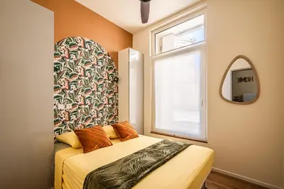 a small bedroom with a bed and a window at Appart BonaVita Narbona in Narbonne