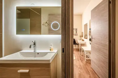 a bathroom with a sink and a mirror at Appart BonaVita Narbona in Narbonne