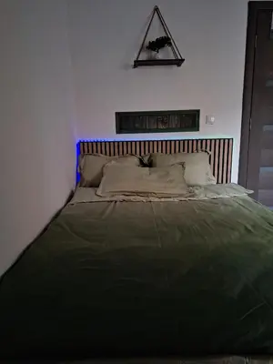 a bedroom with a bed with a green blanket at Galamus Bonheur - L'art de choisir in Saint-Paul-de-Fenouillet