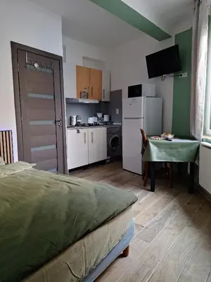 a room with a kitchen with a bed and a table at Galamus Bonheur - L'art de choisir in Saint-Paul-de-Fenouillet