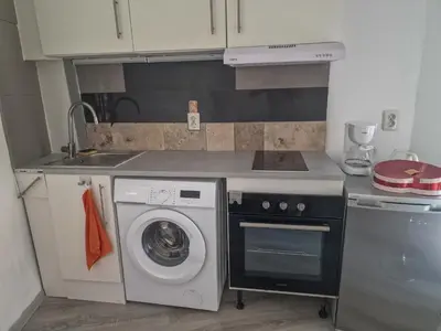 a kitchen with a washing machine and a sink at Galamus Bonheur - L'art de choisir in Saint-Paul-de-Fenouillet