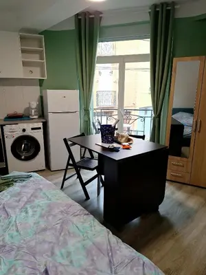 a bedroom with a desk and a kitchen with a bed at Galamus Bonheur - L'art de choisir in Saint-Paul-de-Fenouillet