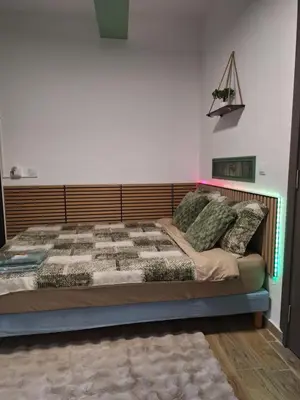 a bedroom with a large bed with a wooden headboard at Galamus Bonheur - L'art de choisir in Saint-Paul-de-Fenouillet