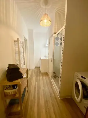 a bathroom with a walk in shower and a washing machine at Hyper centre - Ecusson in Castres