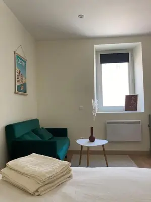 a bedroom with a bed and a couch and a table at Hyper centre - Ecusson in Castres