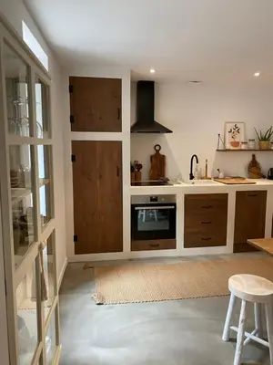 a kitchen with wooden cabinets and a stove at Joli appartement en ville in Revel