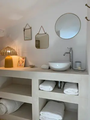 a bathroom with a sink and a mirror and towels at Joli appartement en ville in Revel