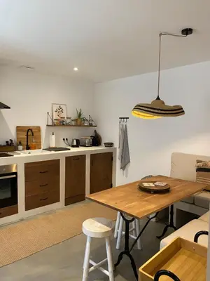 a kitchen with a wooden table and a dining room at Joli appartement en ville in Revel