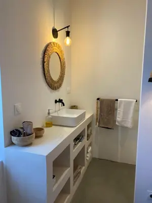 a bathroom with a white sink and a mirror at Joli appartement en ville in Revel