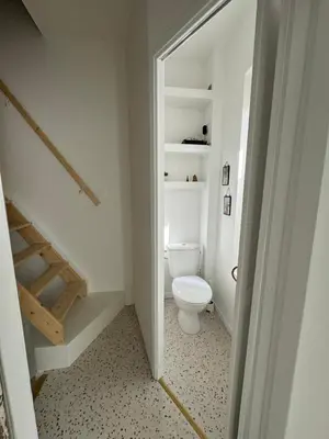 a bathroom with a white toilet in a room at Joli appartement en ville in Revel