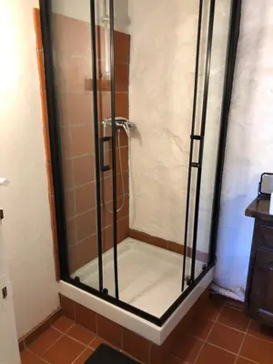 a shower with a glass door in a bathroom at Le balcon d hautpoul in Mazamet