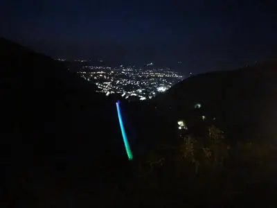 a green light on the side of a hill at night at Le balcon d hautpoul in Mazamet