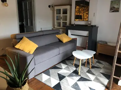a living room with a couch and a table at Le balcon d hautpoul in Mazamet