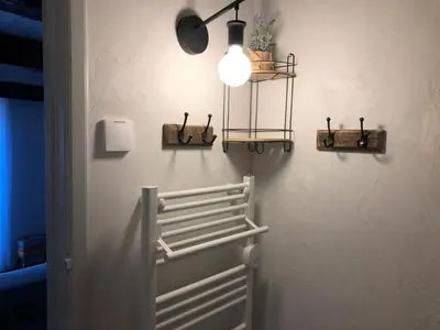 a light hanging from a wall with a radiator at Le balcon d hautpoul in Mazamet