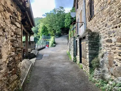 an alley between two stone buildings with at Le balcon d hautpoul in Mazamet