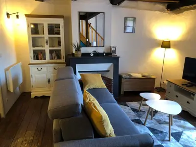 a living room with a blue couch and a fireplace at Le balcon d hautpoul in Mazamet