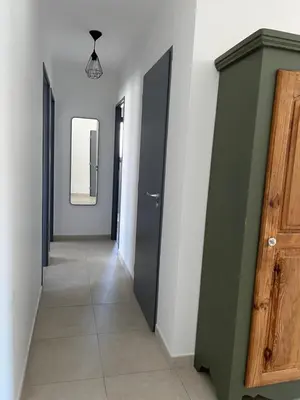 a hallway with two doors and a tile floor at Maison quartier la Campane Narbonne in Narbonne